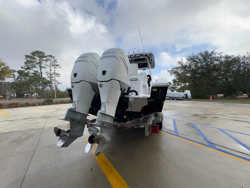 Slide: The Image of 2018 Fountain 34 CC boat with dual outboard motors on a trailer. - 16