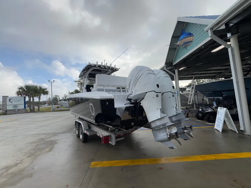 Slide: The Image of 2018 Fountain 34 CC boat on trailer at marina, overcast sky. - 18