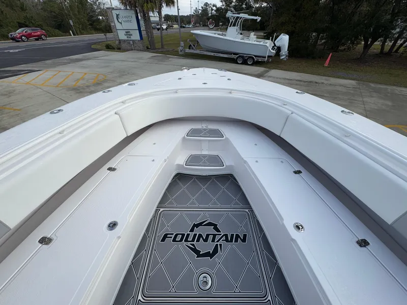 Slide: The Image of 2018 Fountain 34 CC boat deck with logo, parked on a trailer. - 19