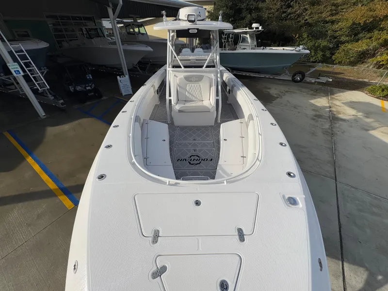 Slide: The Image of 2018 Fountain 34 CC boat, white exterior, docked at marina. - 21