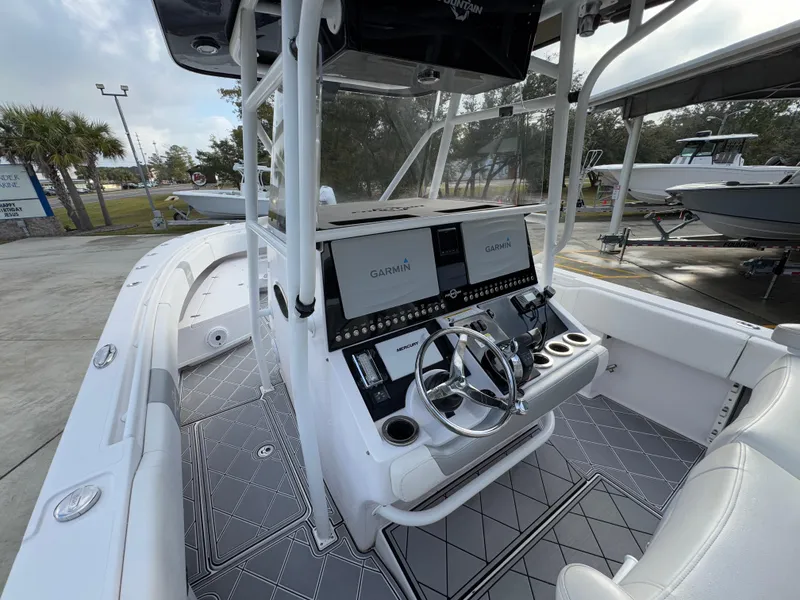 Slide: The Image of 2018 Fountain 34 CC boat interior with dual Garmin displays and steering wheel. - 29