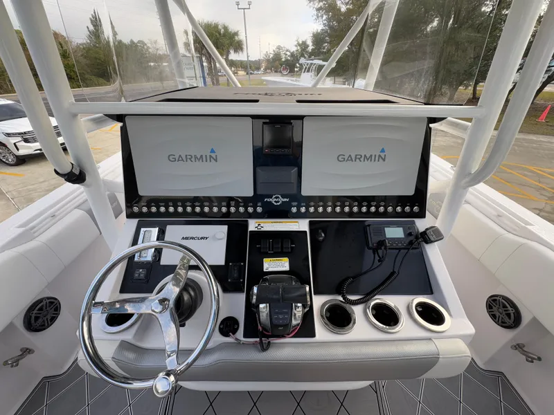 Slide: The Image of 2018 Fountain 34 CC boat dashboard with Garmin displays and Mercury controls. - 30