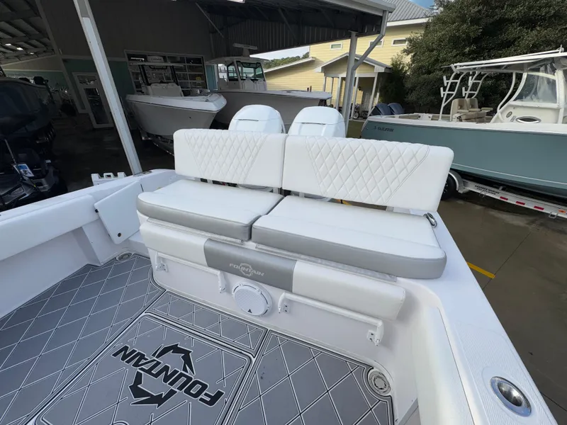 Slide: The Image of 2018 Fountain 34 CC boat interior with cushioned seating and logo flooring. - 34