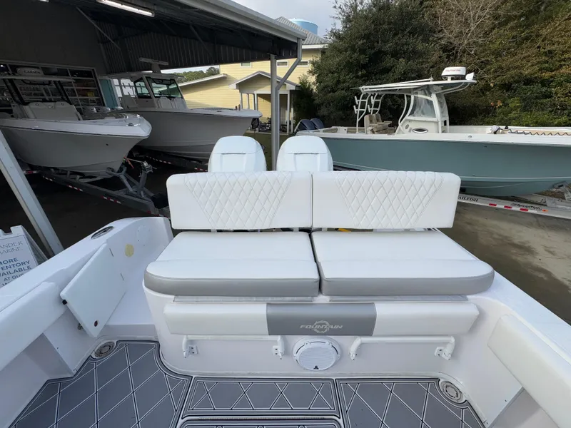 Slide: The Image of 2018 Fountain 34 CC boat interior with white cushioned seating and sleek design. - 35
