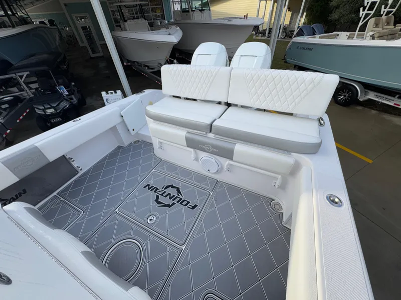 Slide: The Image of 2018 Fountain 34 CC boat interior with white seating and custom flooring. - 36