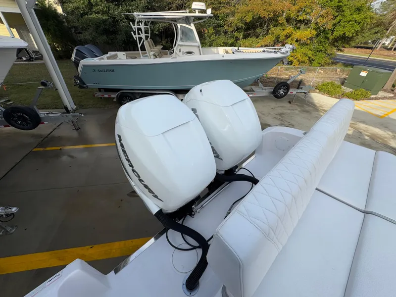 Slide: The Image of 2018 Fountain 34 CC boat with twin Mercury outboard engines, parked on a trailer. - 37