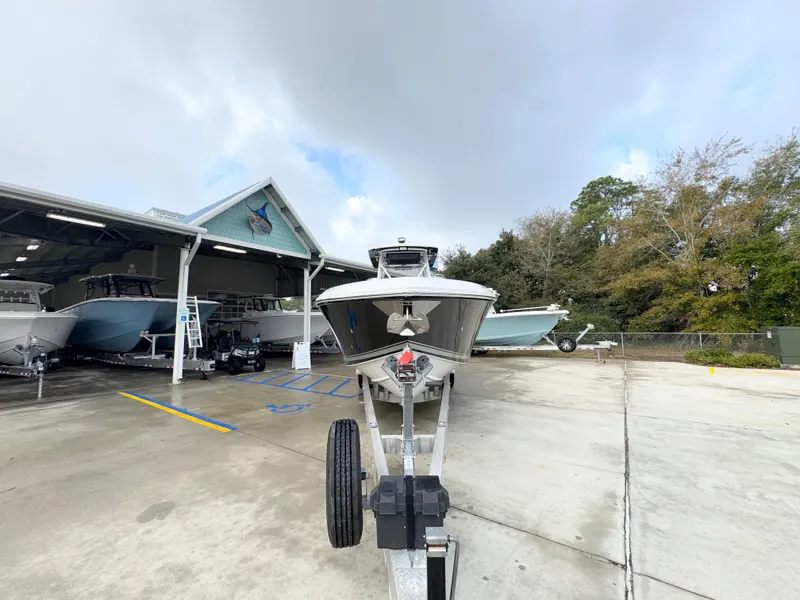 Slide: The Image of 2018 Fountain 34 CC boat on trailer at marina, cloudy sky background. - 7