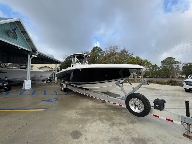 Slide: The Image of 2018 Fountain 34 CC boat on trailer at dealership, cloudy sky background. - 8