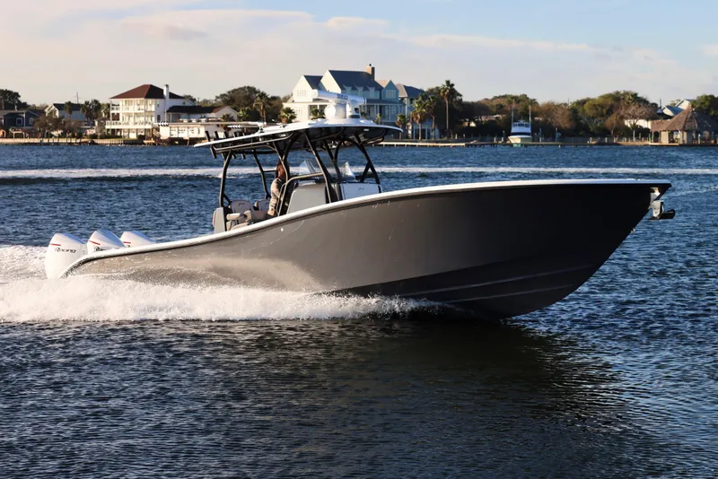 Slide: The Image of 2023 Yellowfin 36 Offshore boat cruising on a scenic waterway. - 4