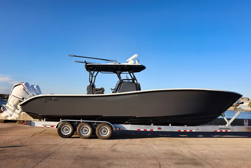 Slide: The Image of 2023 Yellowfin 36 Offshore boat on trailer, side view, clear sky background. - 9