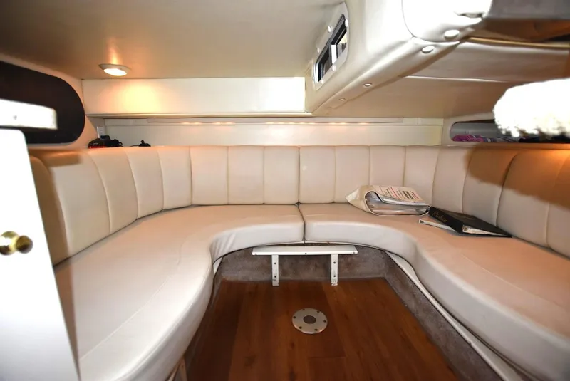 Slide: The Image of Interior of 2000 Rinker 342 Fiesta Vee boat with curved seating and wood flooring. - 12
