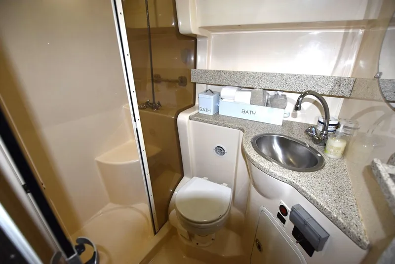 Slide: The Image of Compact bathroom in 2000 Rinker 342 Fiesta Vee yacht with shower, toilet, and sink. - 13