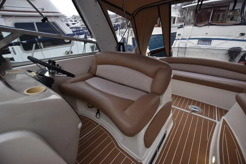 Slide: The Image of Interior of 2000 Rinker 342 Fiesta Vee boat with brown seating and wood flooring. - 6