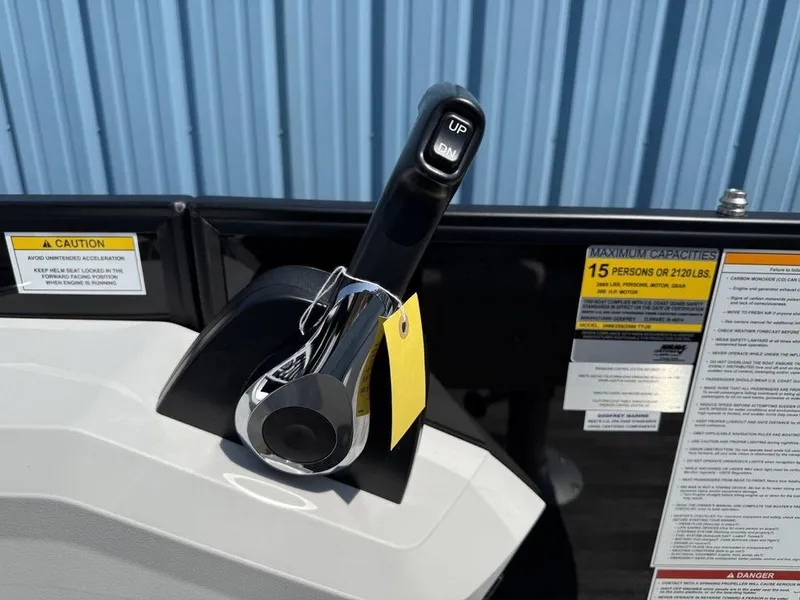 Slide: The Image of Control lever on 2025 Godfrey Sweetwater 2486 DT boat, with caution and capacity labels. - 11