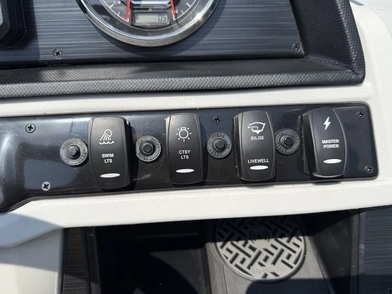 Slide: The Image of Control panel of 2025 Godfrey Sweetwater 2486 DT boat with labeled switches. - 15