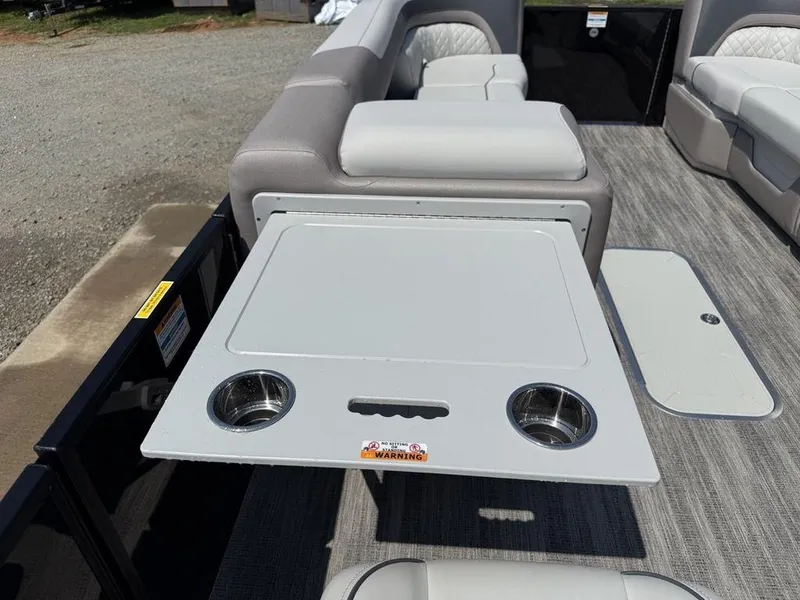 Slide: The Image of Interior of 2025 Godfrey Sweetwater 2486 DT boat with seating and foldable table. - 16