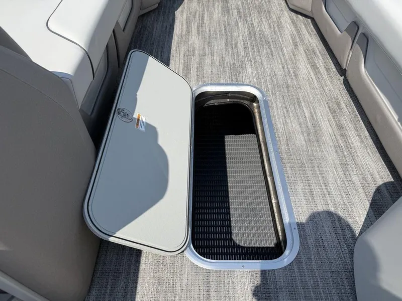 Slide: The Image of 2025 Godfrey Sweetwater 2486 DT boat interior storage compartment with open hatch. - 20