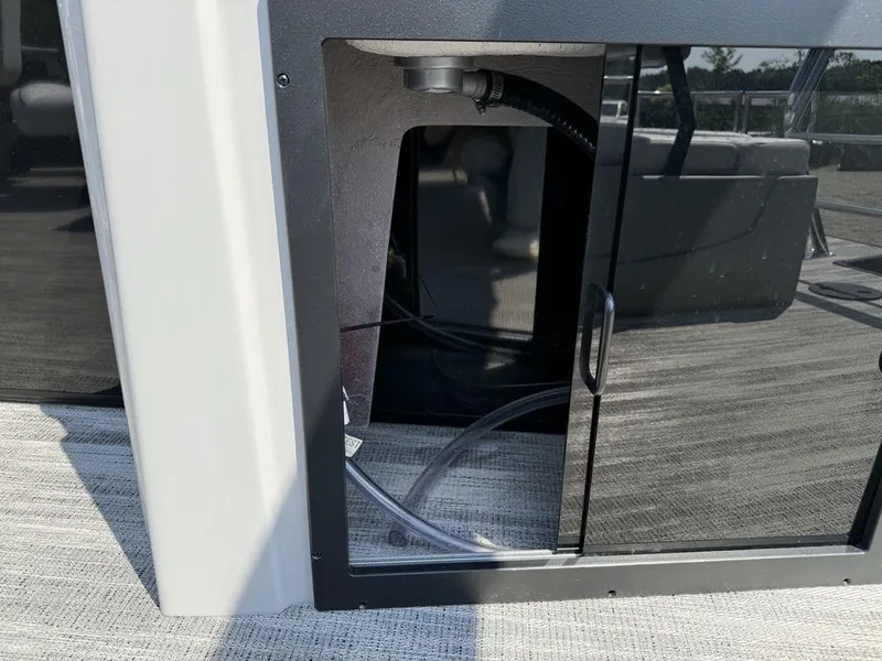 Slide: The Image of Open storage compartment on 2025 Godfrey Sweetwater 2486 DT pontoon boat. - 27