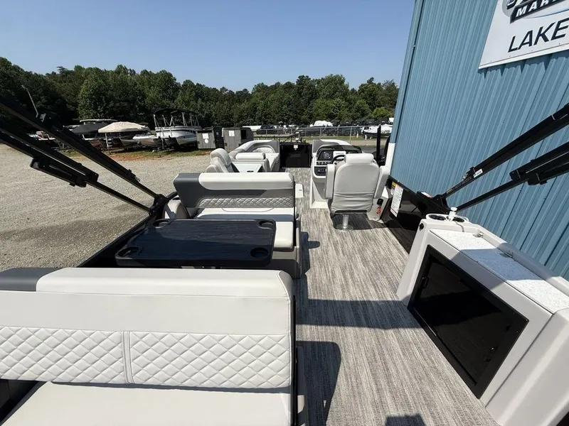 Slide: The Image of 2025 Godfrey Sweetwater 2486 DT pontoon boat interior with seating and control console. - 28