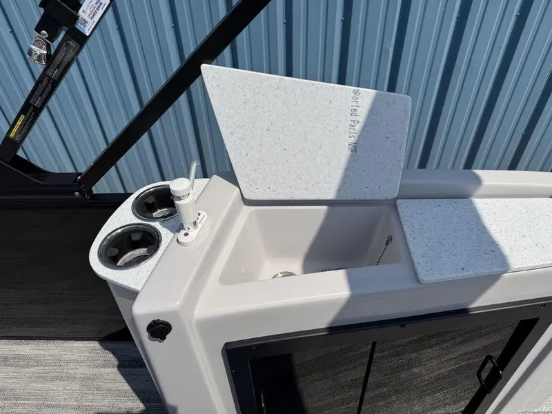 Slide: The Image of 2025 Godfrey Sweetwater 2486 DT boat sink and cup holders, featuring modern design elements. - 30