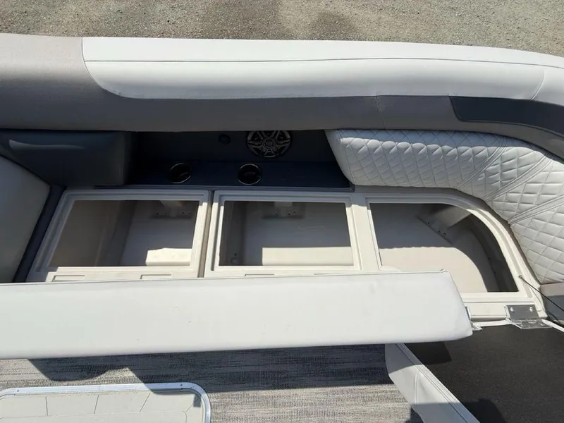 Slide: The Image of 2025 Godfrey Sweetwater 2486 DT boat interior storage compartments with quilted seating. - 4