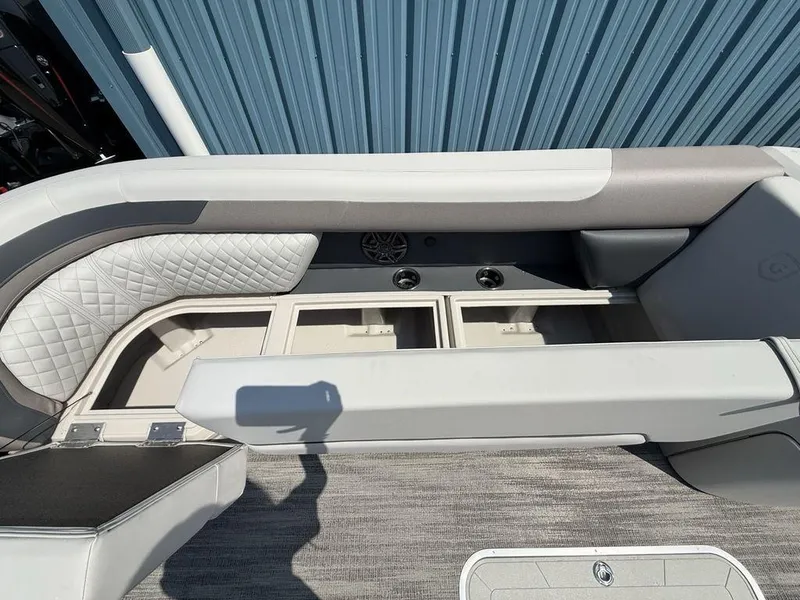 Slide: The Image of Interior of 2025 Godfrey Sweetwater 2486 DT boat, featuring seating and storage compartments. - 7