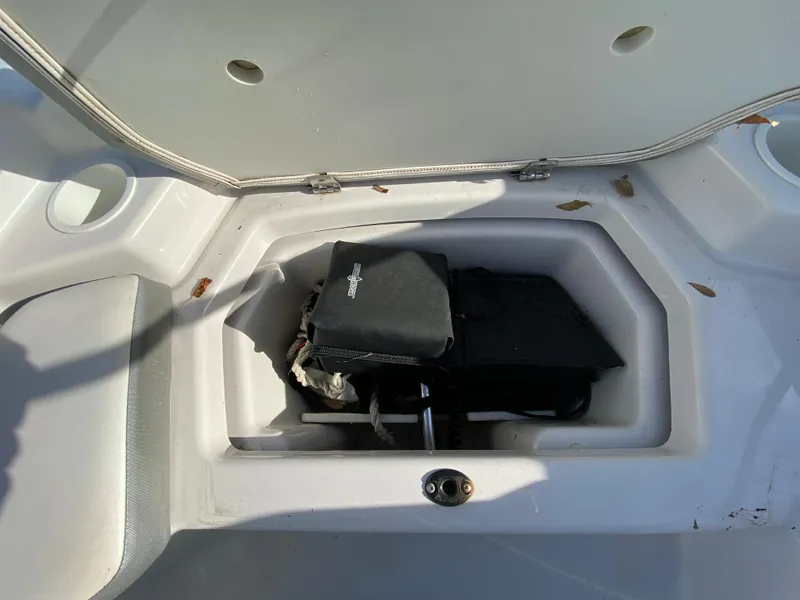 Slide: The Image of Open storage compartment in 2018 Scarab 165 G boat with equipment inside. - 16