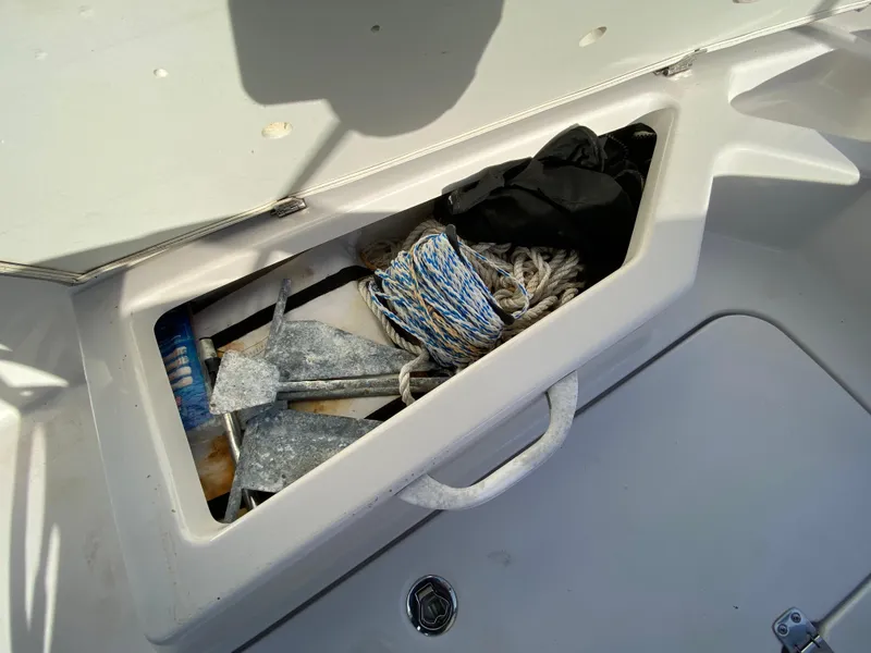 Slide: The Image of Open storage compartment on 2018 Scarab 165 G boat with ropes and anchor. - 17