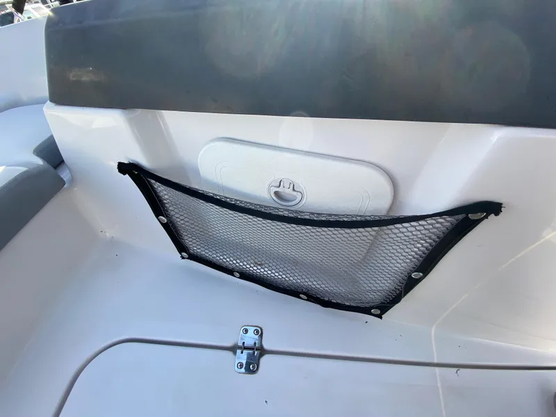 Slide: The Image of Scarab 165 G 2018 boat interior with storage net and latch. - 18
