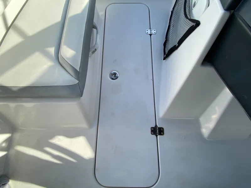 Slide: The Image of Interior view of a 2018 Scarab 165 G boat, featuring a storage compartment. - 20