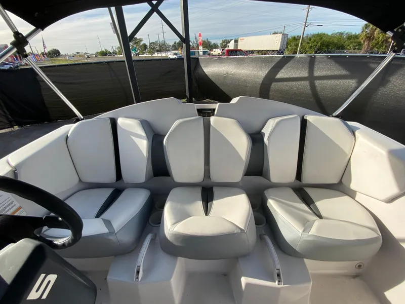 Slide: The Image of 2018 Scarab 165 G boat interior with white and gray seating. - 25
