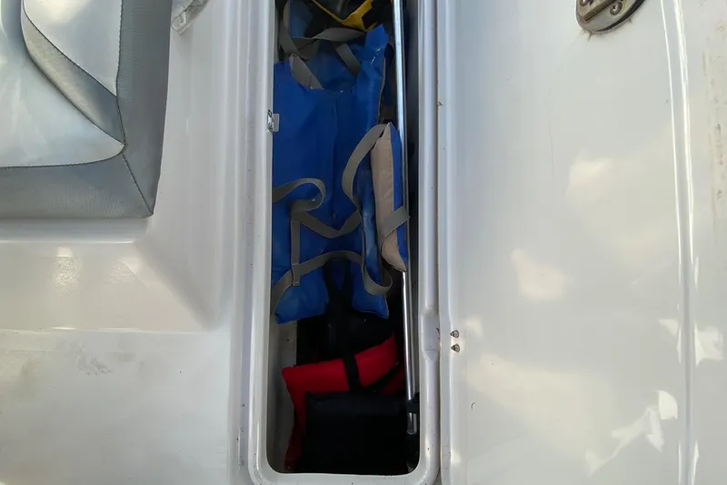 Slide: The Image of Storage compartment in 2018 Scarab 165 G boat with life jackets. - 30