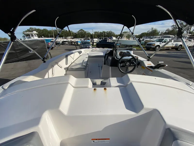 Slide: The Image of 2018 Scarab 165 G boat interior with steering wheel and seating area. - 8
