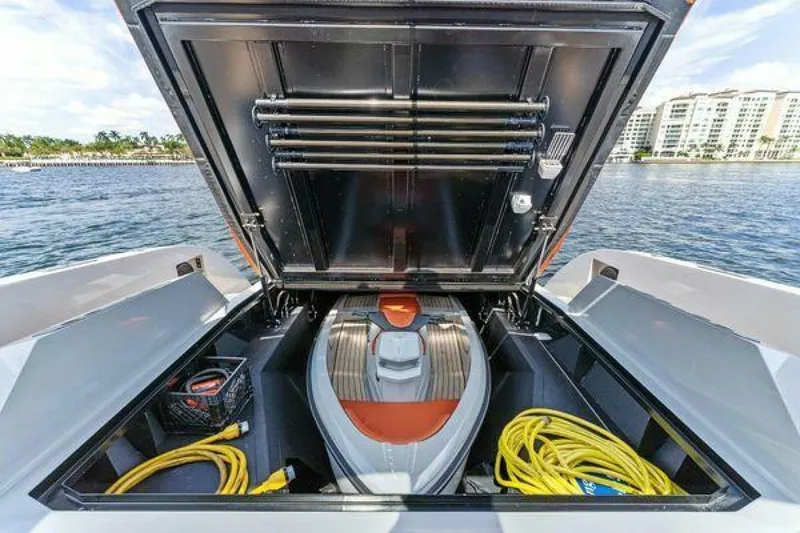 Slide: The Image of 2021 Vanquish VQ58 yacht storage compartment with watercraft and equipment. - 33