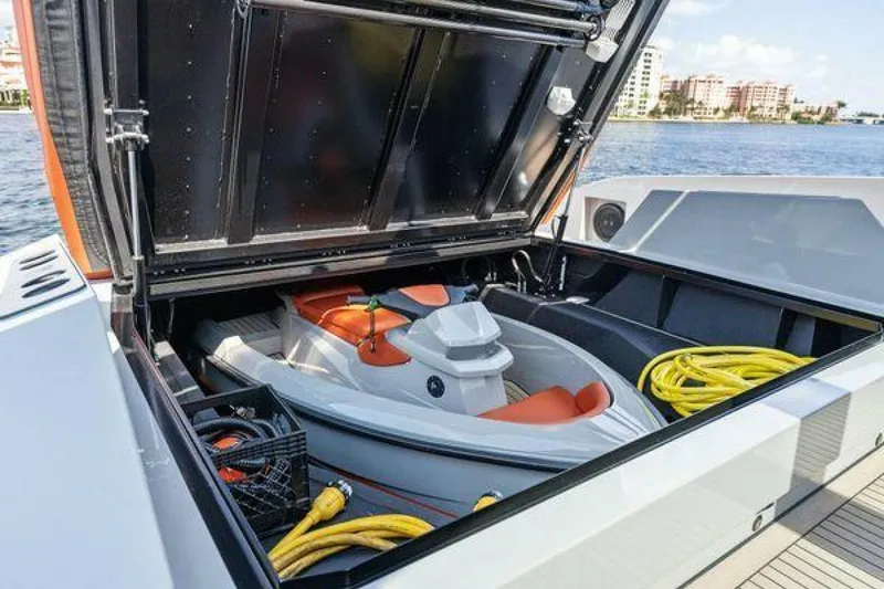 Slide: The Image of Vanquish VQ58 yacht with jet ski storage, 2021 model, docked by waterfront buildings. - 34