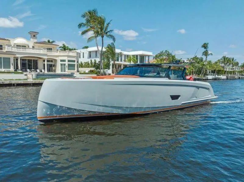 Slide: The Image of Luxury Vanquish VQ58 yacht cruising near waterfront homes, 2021 model. - 39