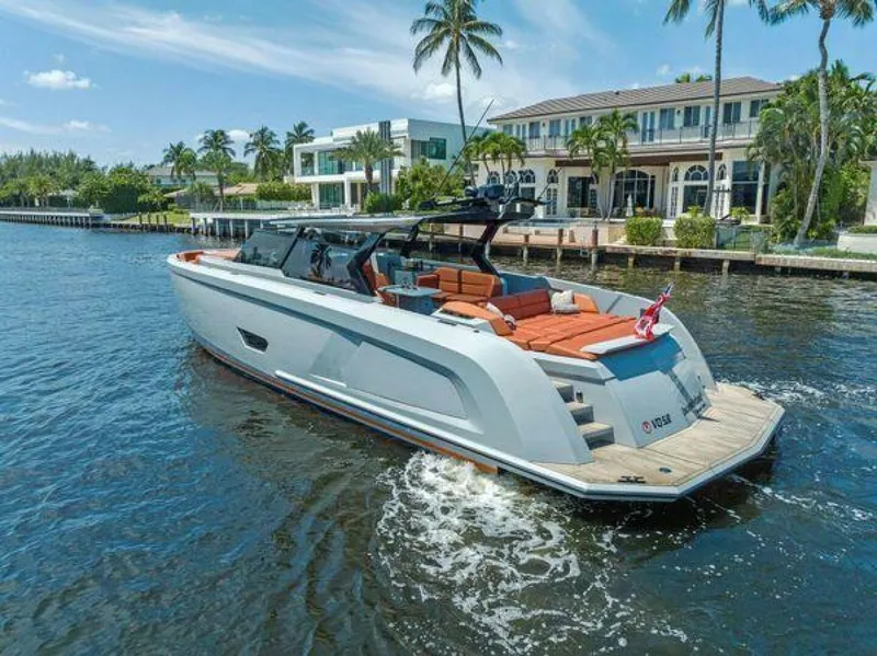 Slide: The Image of Luxury 2021 Vanquish VQ58 yacht cruising near waterfront homes and palm trees. - 41