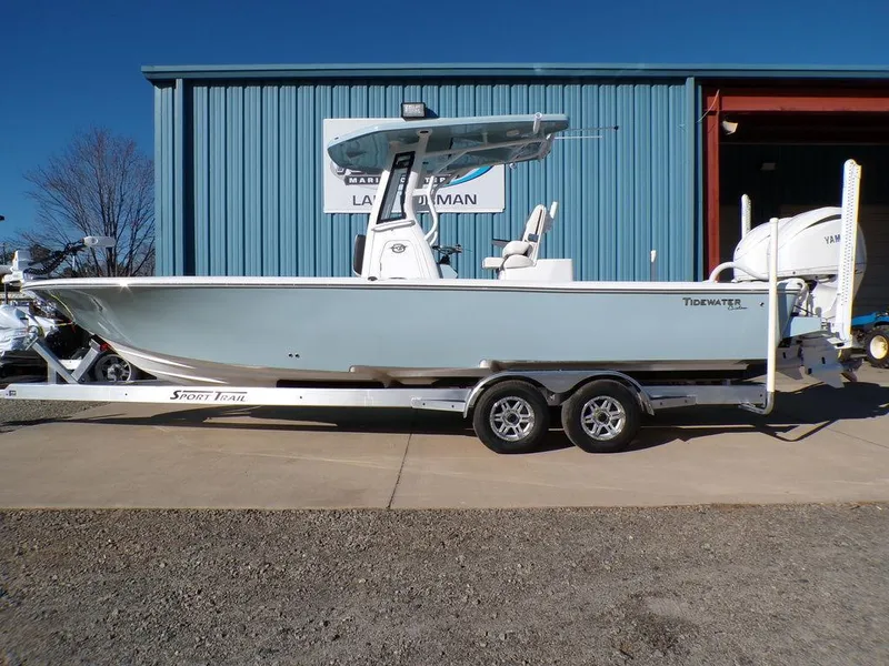The Image of 2025 Tidewater 2700 CB boat on trailer outside a blue building. - 0