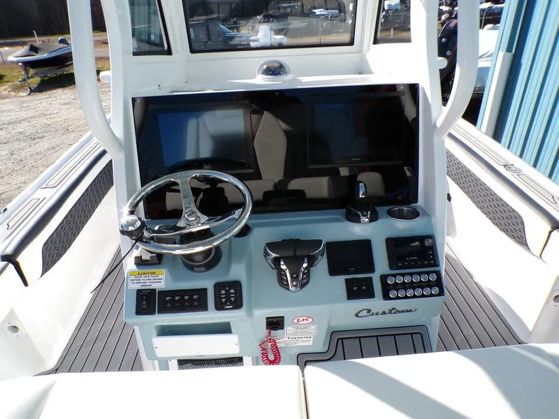 Slide: The Image of 2025 Tidewater 2700 CB boat console with steering wheel and controls. - 14