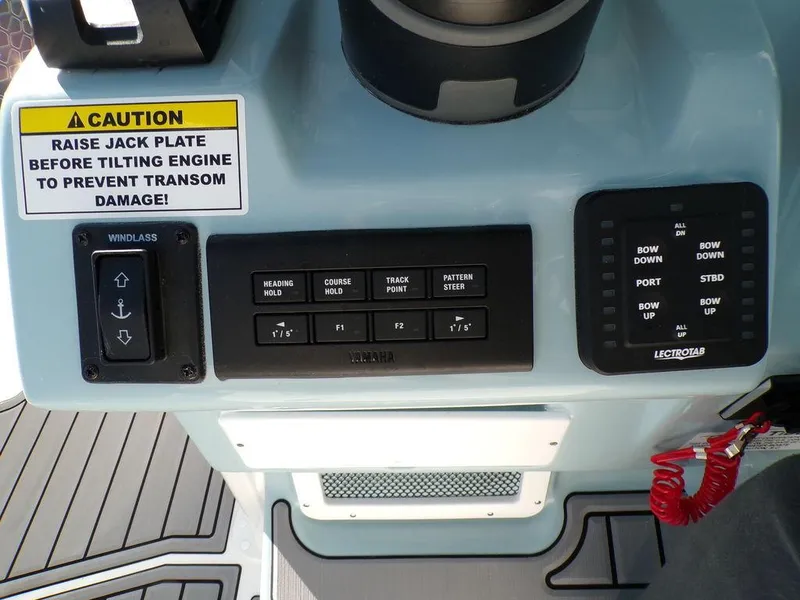 Slide: The Image of Control panel of 2025 Tidewater 2700 CB boat with caution label and various switches. - 16