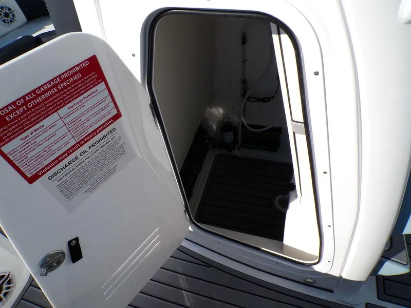 Slide: The Image of 2025 Tidewater 2700 CB boat interior storage compartment with open door. - 19