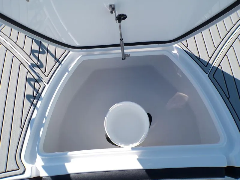 Slide: The Image of 2025 Tidewater 2700 CB boat storage compartment with open lid and bucket. - 20