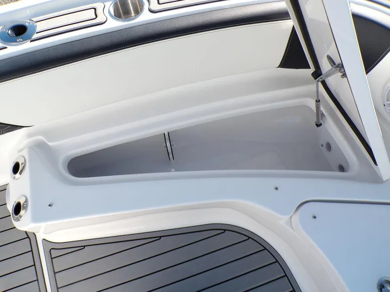 Slide: The Image of 2025 Tidewater 2700 CB boat storage compartment with open hatch and sleek design. - 21