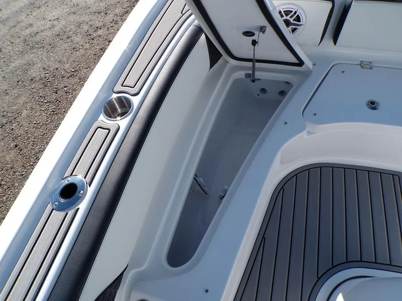 Slide: The Image of 2025 Tidewater 2700 CB boat interior with storage compartment and cup holders. - 24