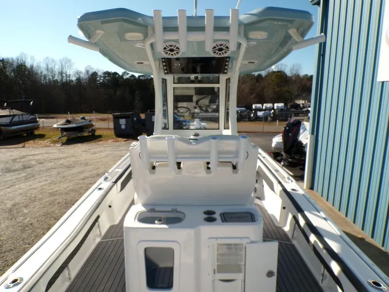 Slide: The Image of 2025 Tidewater 2700 CB boat with center console and rod holders, docked outdoors. - 9