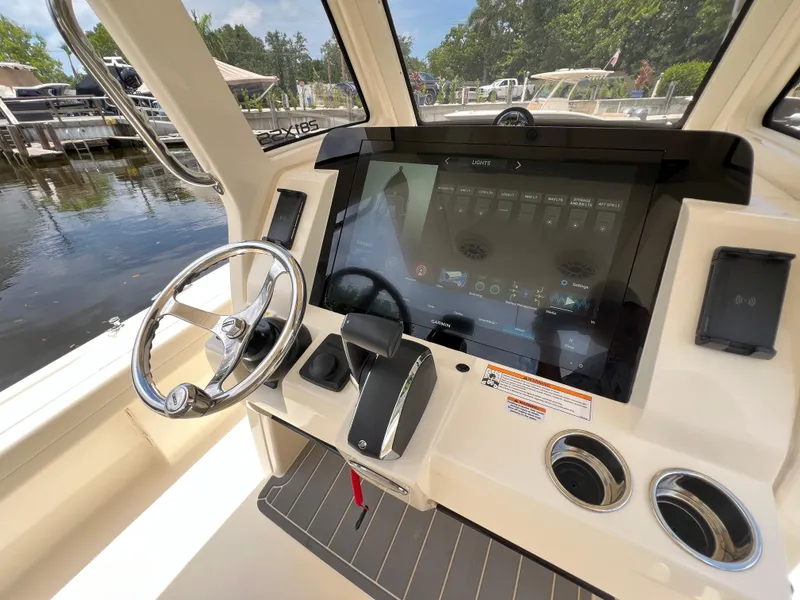 Slide: The Image of 2025 Scout 281 XSS boat dashboard with touchscreen controls and steering wheel. - 11