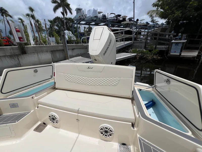 Slide: The Image of 2025 Scout 281 XSS boat interior with seating and storage compartments. - 18