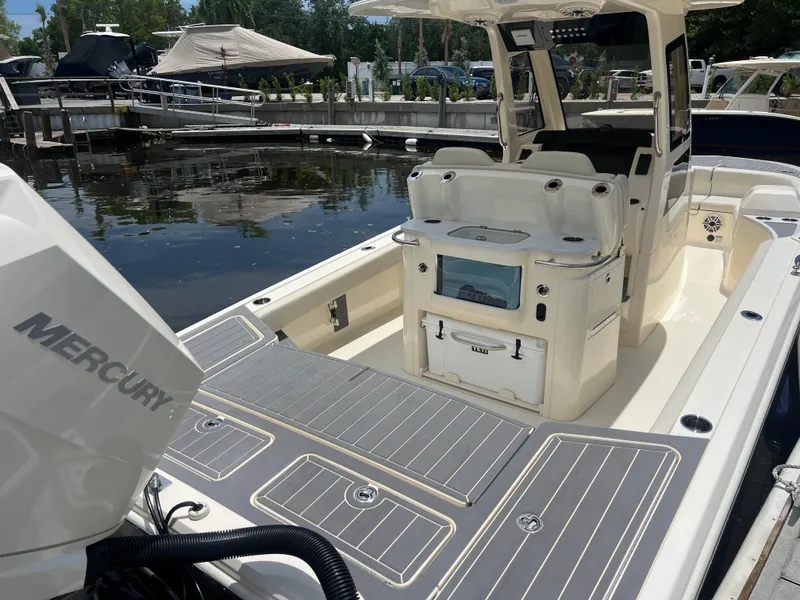 Slide: The Image of 2025 Scout 281 XSS boat with Mercury engine, docked at marina. - 20