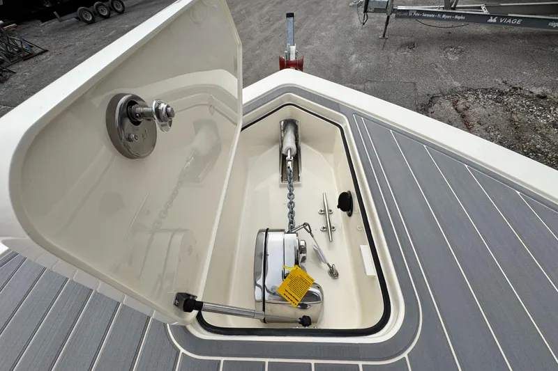 Slide: The Image of Open anchor locker on 2025 Scout 281 XSS boat, showcasing chain and winch. - 4