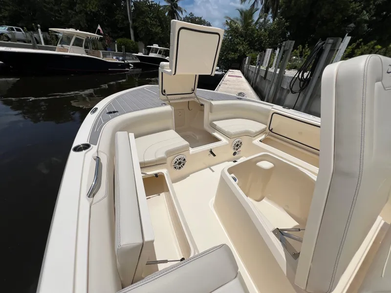 Slide: The Image of 2025 Scout 281 XSS boat interior with open storage compartments and seating. - 7